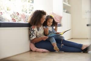 Mother and daughter reading a book together