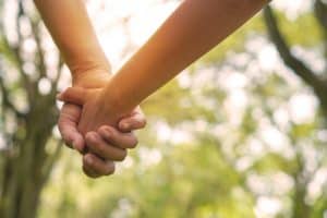 Two hands holding outside
